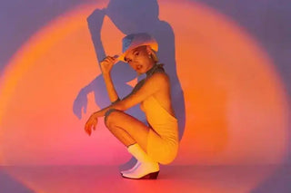 Figure in a yellow outfit crouching in a dynamic pose.