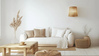 White upholstered sofa with beige and white throw pillows.